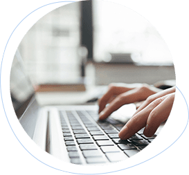 two hands typing on a laptop